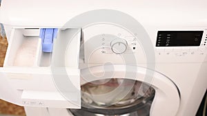 Detergent Filling to Washing Machine by Woman Hand