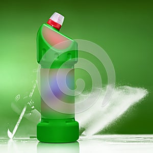 Detergent in a green bottle on a green and white background