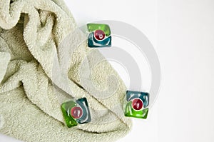 Detergent pods and towel isolated on white. minimalism of detergent. laundry detergent. copy space