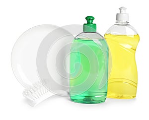 Detergents, brush and plate on background. Clean dishes