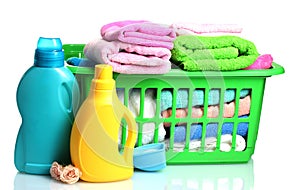 Detergents and towels in green plastic basket