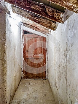 Deteriorated door in an abandoned and dirty attic