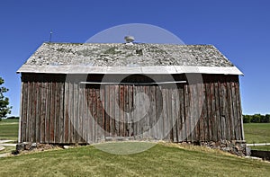 Deteriorating roof of an old barn or shed in a deteriorating condition.