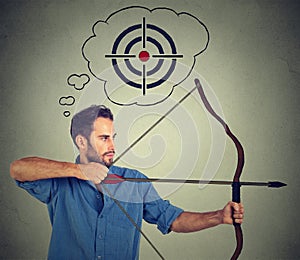 Determinate business man with bow and arrow. photo