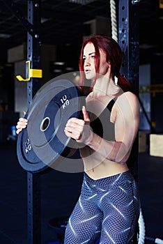 Determined athlete lifting barbells looking focused
