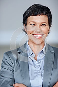 Determined business woman. Portrait of successful mature female executive smiling.