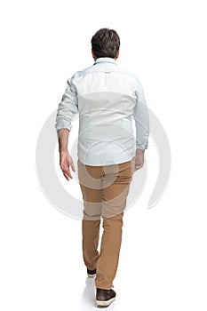 Determined casual man walking forward hurried