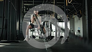 Determined Caucasian sportsman active athlete man bodybuilder training in gym muscular guy masculine workout with battle