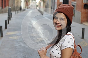 Determined ethnic woman smiling on the street