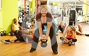 Determined fat woman training in health club