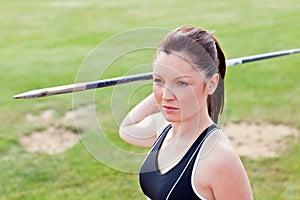 Determined female athlete ready to throw javelin