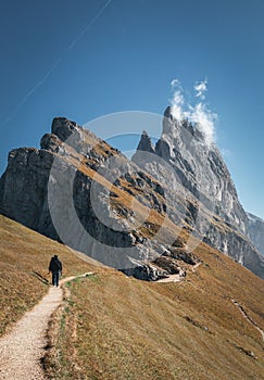 Determined individual is making their way up a rugged mountain path