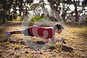 Determined kid exercising during obstacle course