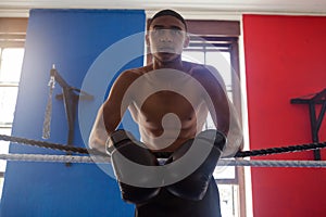 Determined man leaning on rope