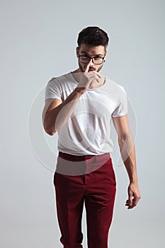 Determined man walking forward and adjusting his glasses