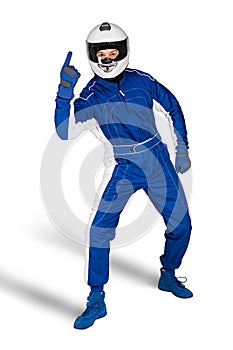 Determined race driver in blue white motorsport overall shoes gloves integral safety crash helmet and victory finger white