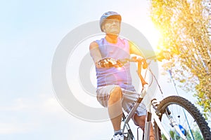 Determined senior man riding bicycle in park