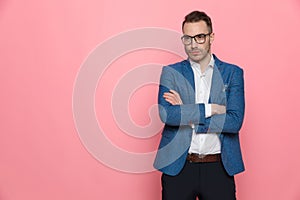 Determined smart casual man holding his arms folded