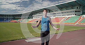 Determined sportsman exercising with jumping rope