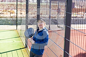 Determined sporty young woman playing padel in court