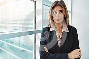 Determined to do my best in business. Portrait of a confident businesswoman standing in a modern office.