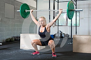 Determined Woman Lifting Weights In Health Club