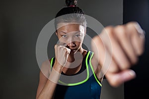 Determined woman practicing boxing in fitness studio