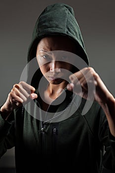 Determined woman practicing boxing in fitness studio