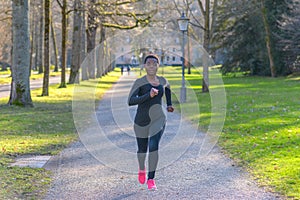 Determined young African woman training in a park