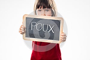Determined young boy with shield against head lice, French poux