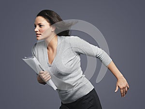 Determined Young Businesswoman Running Into Wind