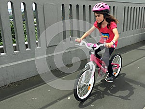 Determined young girl rides a bike