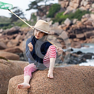 Determined young kid playing fishing with energy for success