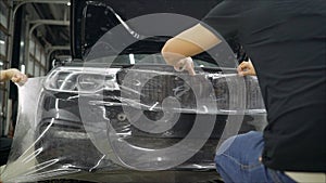 Deteyling car. Sticker protective film on the bumper of the car