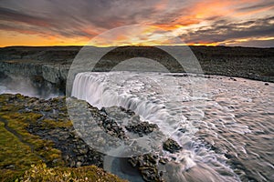 Detifoss waterfall with sunset in the background