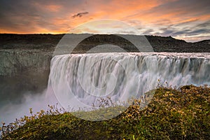 Detifoss waterfall with sunset in the background
