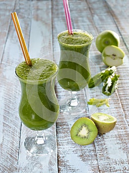 Detox beverage, healthy green juice with apple, kiwi and spinach