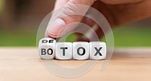 Detox instead of Botox. Hand turns a dice and changes the expression photo
