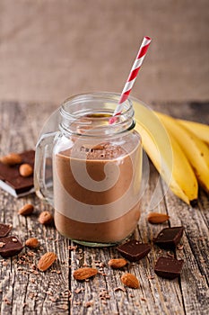 Detox chocolate smoothie with nuts in glass jar.