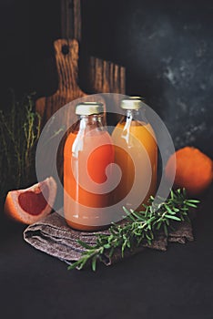 Detox citrus juices in bottle. Fresh grapefruit and orange juice