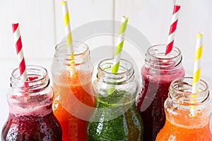 Detox drinks in bottles: fresh smoothies from vegetables: beet, carrot, spinach, cucumber and apple