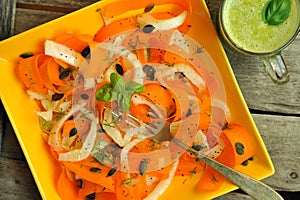 Detox food with raw fennel, carrot salad and fruit juice photo