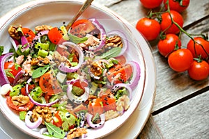 Detox food with veggie, raw salad with tomato and walnuts