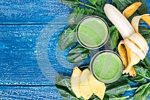 Detox green smoothie with spinach, pineapple, banana and yogurt, horizontal, top view, copy space