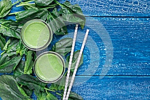 Detox green smoothie with spinach, pineapple, banana and yogurt, top view, copy space