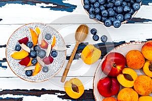 Detox and healthy superfoods breakfast bowl concept. Vegan coconut milk chia seeds pudding over rustic table with various fruits