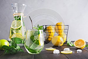 Detox lemonade with mint, citrics in glass on grey