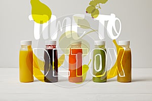 detox smoothies in bottles standing in row, refresh concept, time to