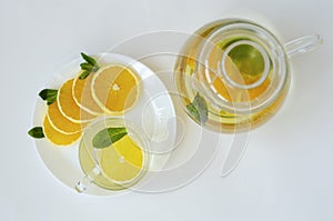 Detox tea with orange fruit and mint on whitw background. Spa and relaxation concept. Copy space. Top view