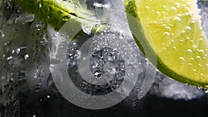 Detox or thirst concept. Healthy, dietary nutrition. Cold lemonade, lime drink. Black background